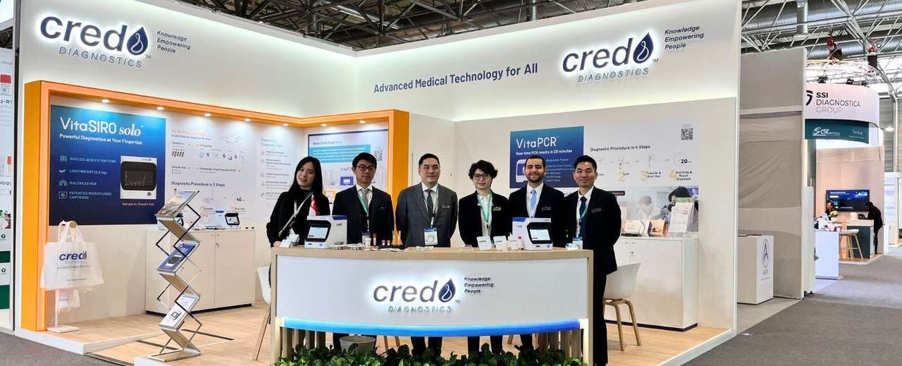 Credo Diagnostics medical technology stand with orange-accented product displays at ESCMID 2025 in Vienna