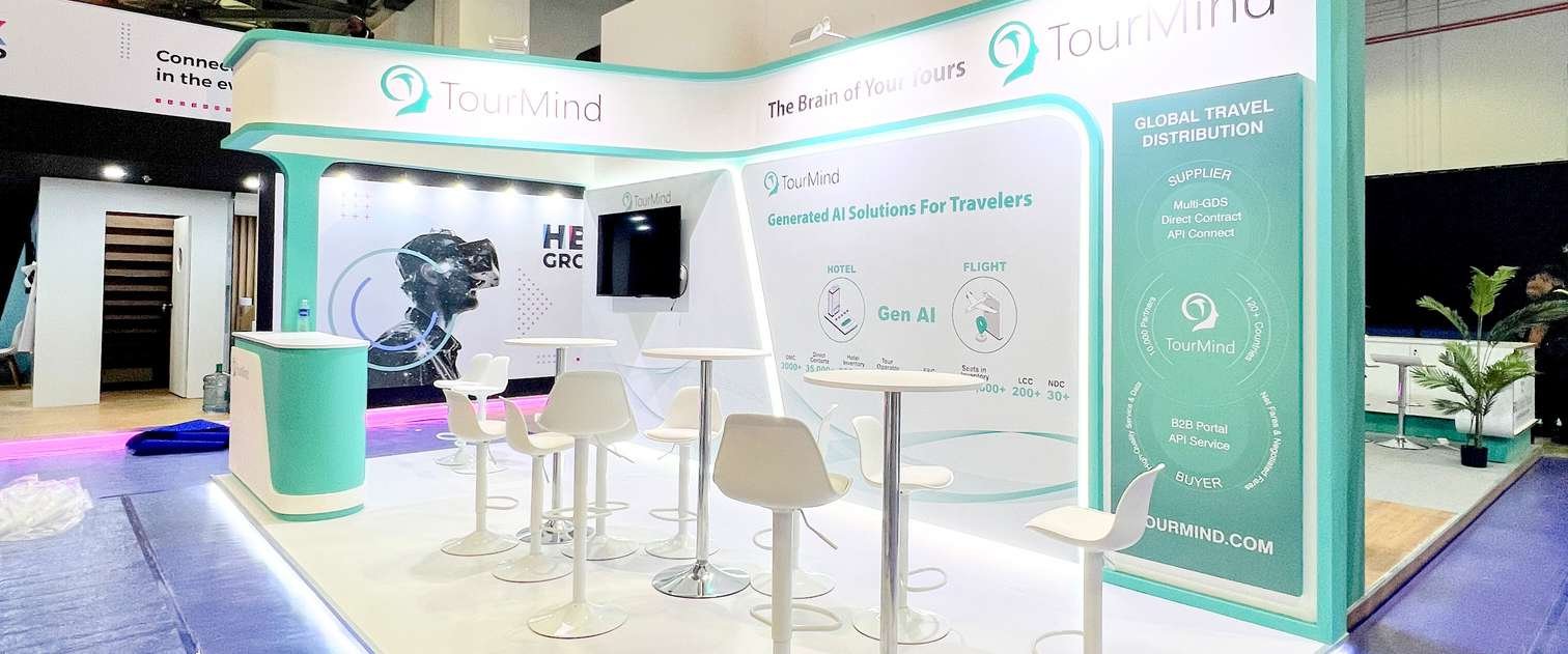 Completed TourMind exhibition stand at WTM London, with brand graphics and meeting tables